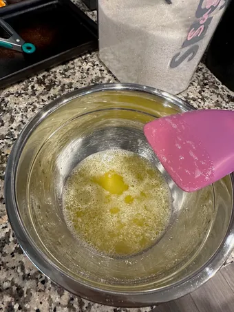 Pale yellow melted butter in a mixing bowl, not yet browned
