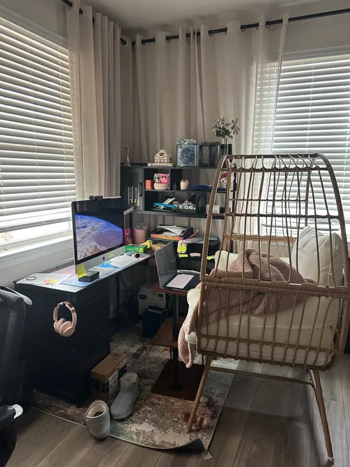 The office as it stands now — the corner with nest chair and curtains is done; the desk behind it remains a work in progress